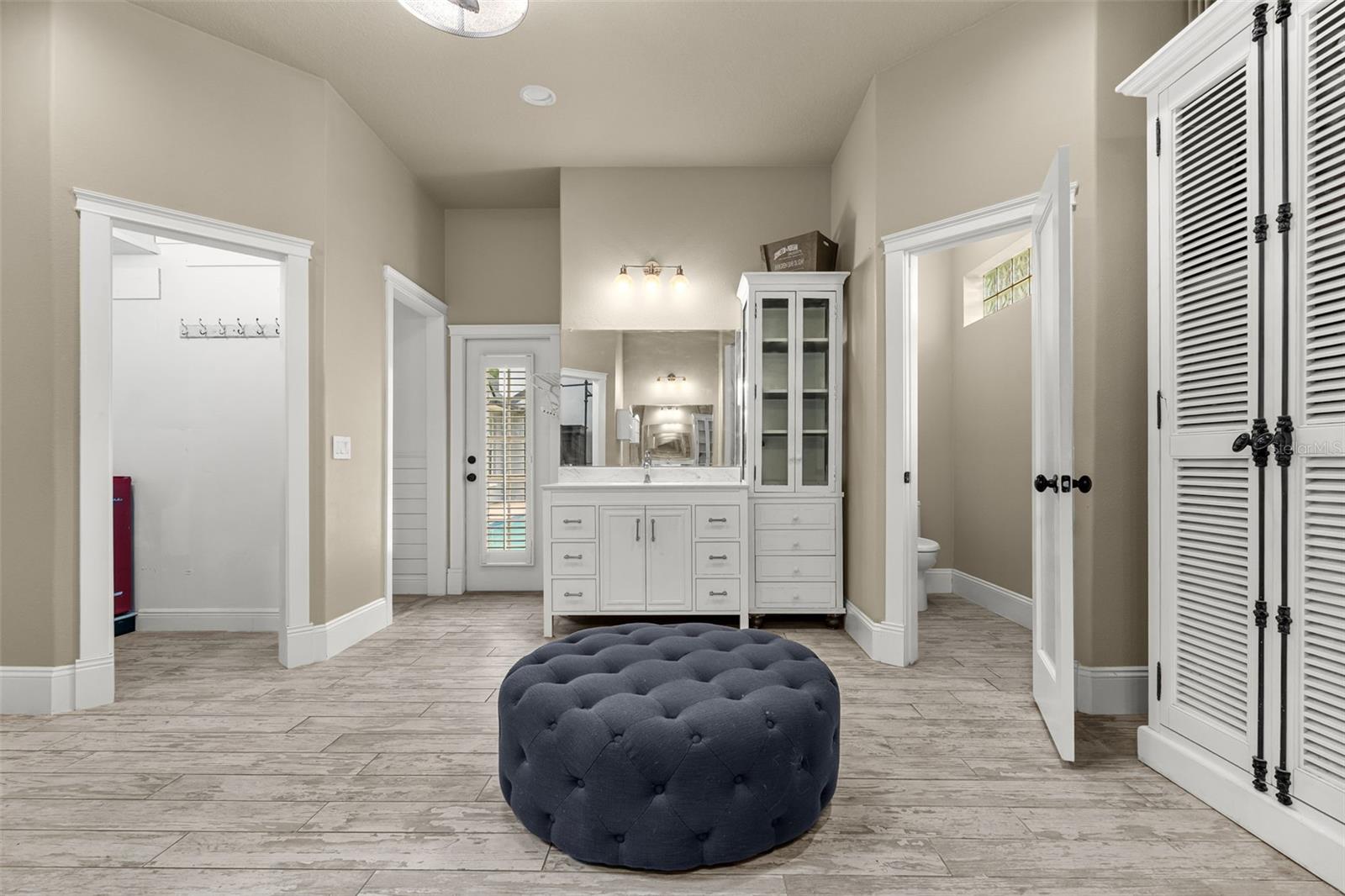 Dual vanities, multiple walk-in closets, and a private water closet create a thoughtfully designed space where every detail serves a purpose.