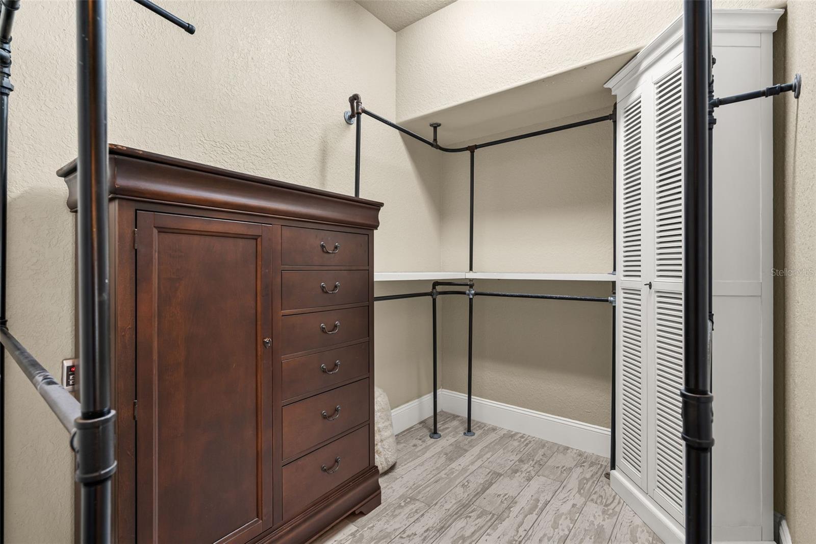 One of several walk-in closets thoughtfully designed to keep the owner's suite beautifully organized.
