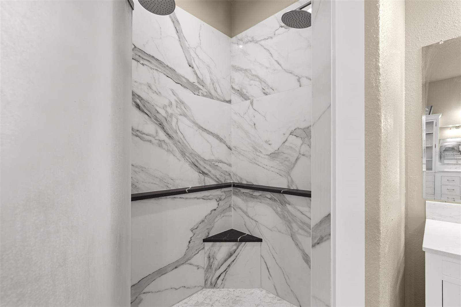 A beautifully appointed walk-in shower completes the luxurious owner's bath.