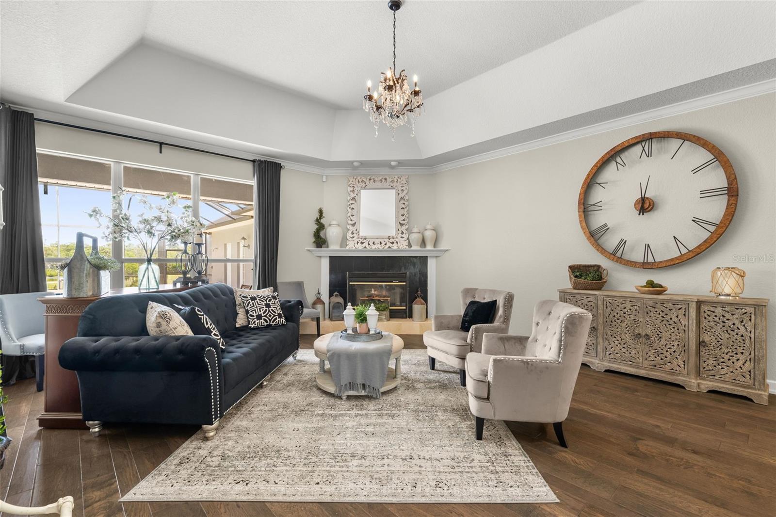 A grand foyer welcomes you into an elegant living space where soaring ceilings and abundant natural light create an unforgettable first impression.