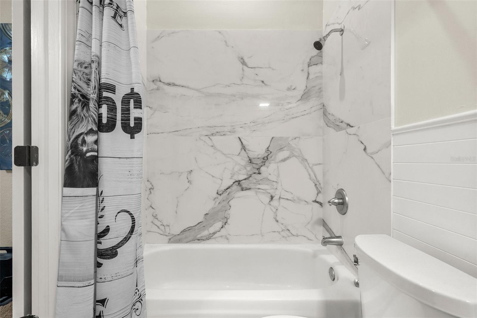 Beautifully finished with timeless materials, the full bath continues the home's commitment to quality and thoughtful design.