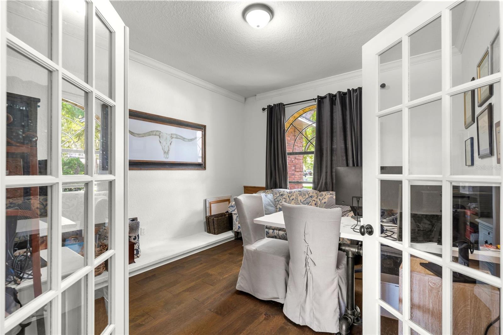 Privately situated off the foyer, this flexible space is ready to become your home office, library, music room, or quiet retreat.