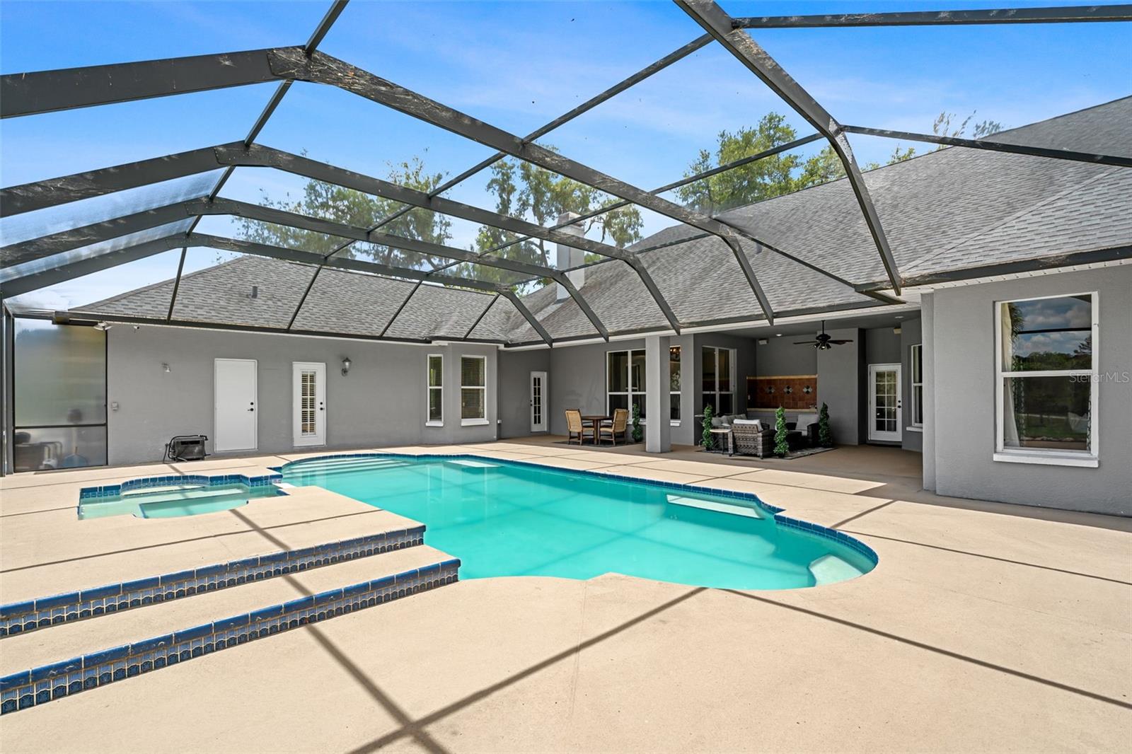 Designed for both relaxation and entertaining, the screened pool creates a private outdoor retreat just steps from the heart of the home.