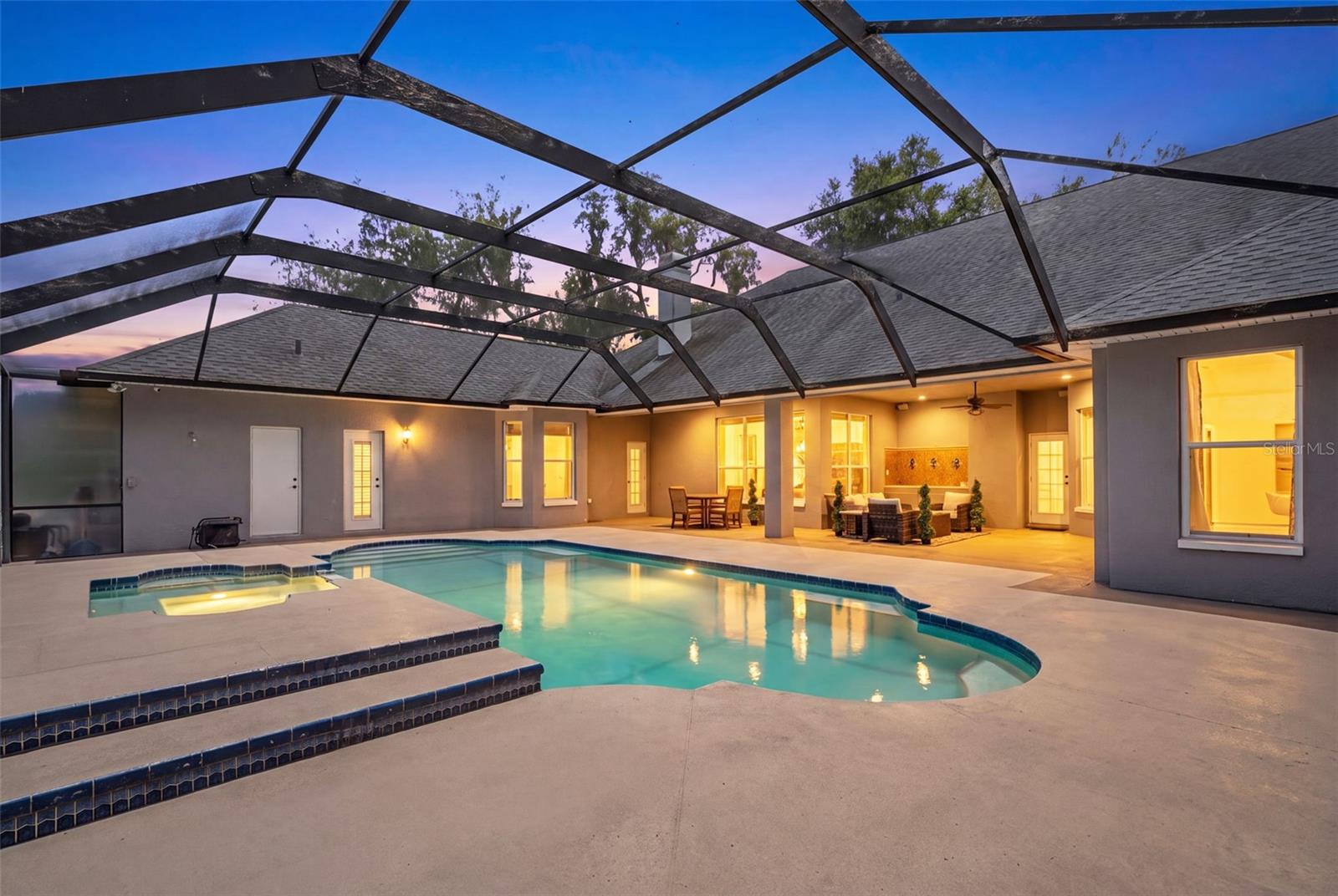 As the sun sets, the outdoor living spaces transform into a warm and inviting backdrop for unforgettable evenings.