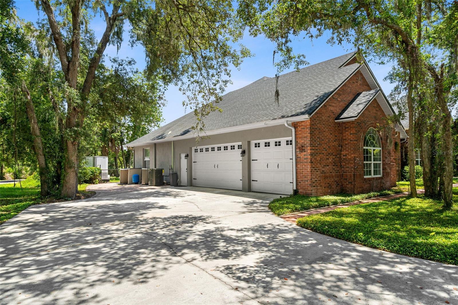 Thoughtfully designed from every angle, the home's expansive driveway and side-entry garage enhance both its curb appeal and everyday convenience.