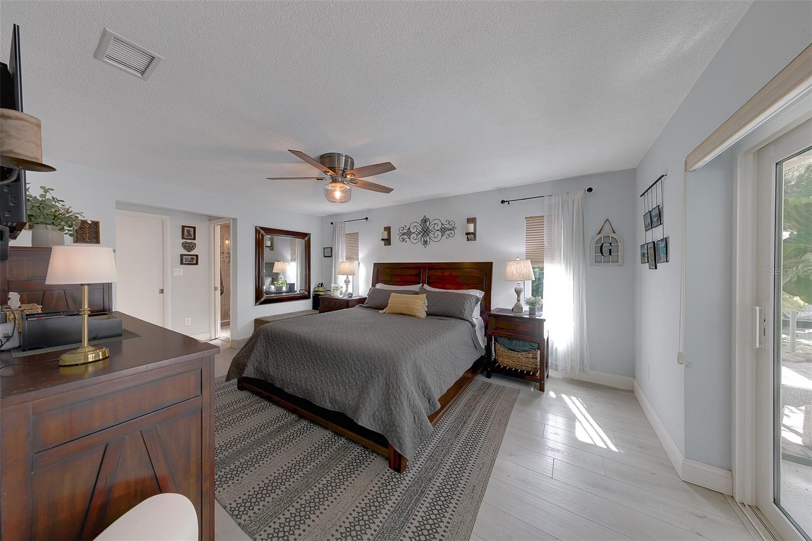 Primary bedroom with walk in closet and a separate linen closet