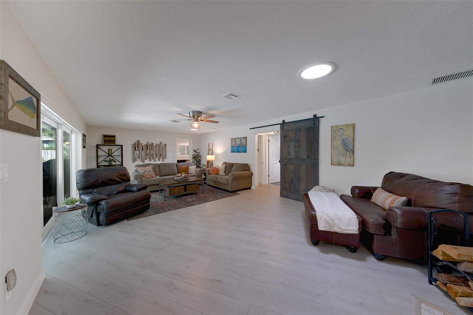 Family room with 3 door sliders opening up to the pool
