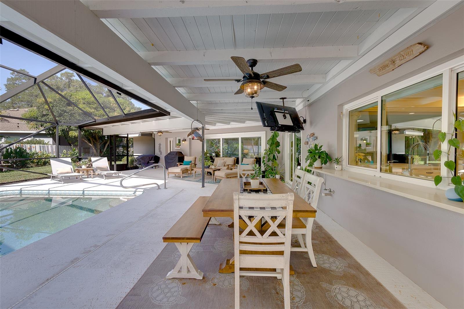 Enclosed porch features 4 ceiling fans