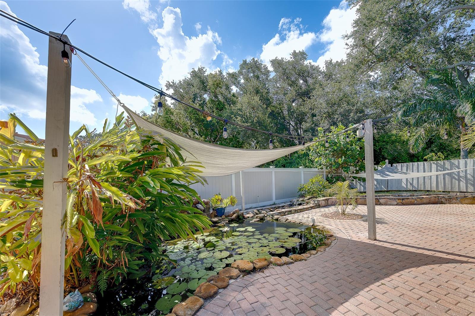 Pavered back patio with koi pond