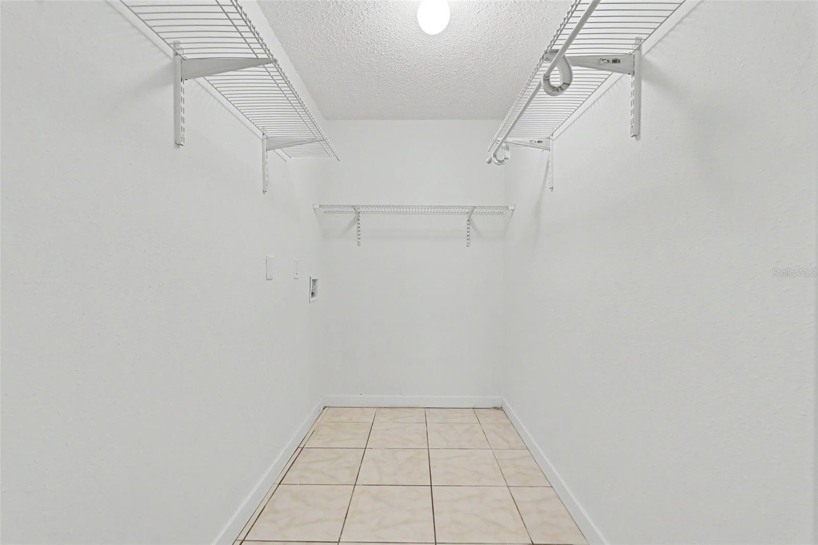 Primary bedroom walk-in closet