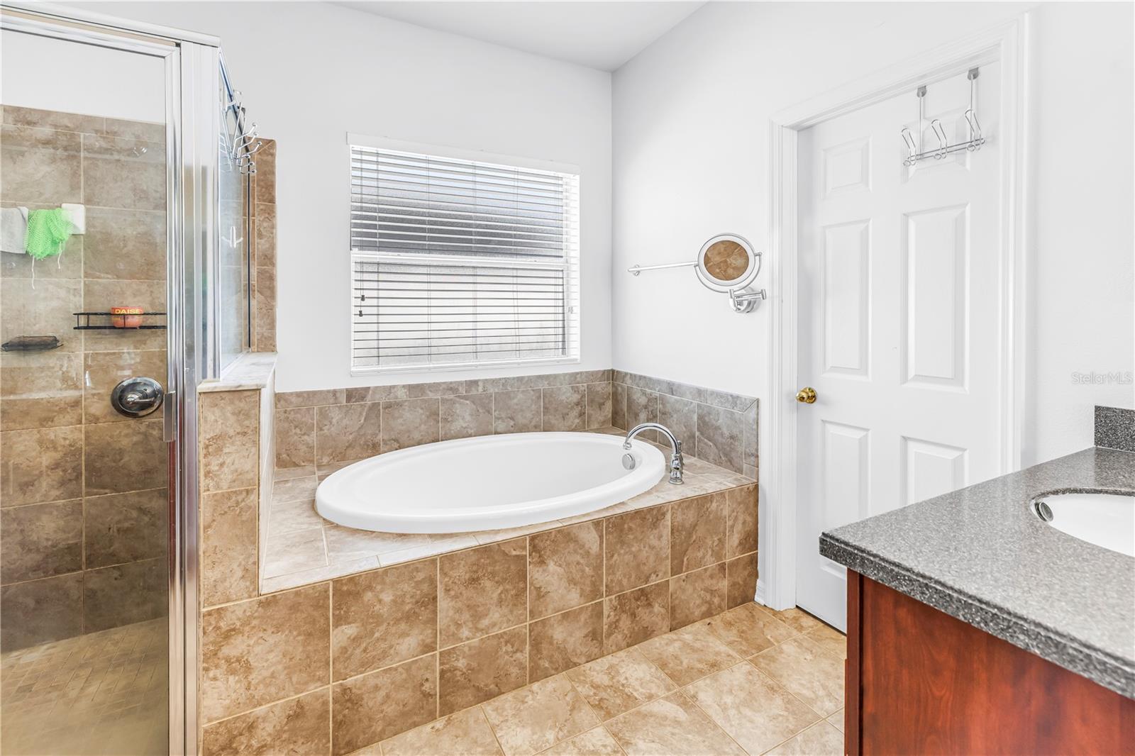 Primary Bath With Soaking Tub and Door to Walk-in Closet