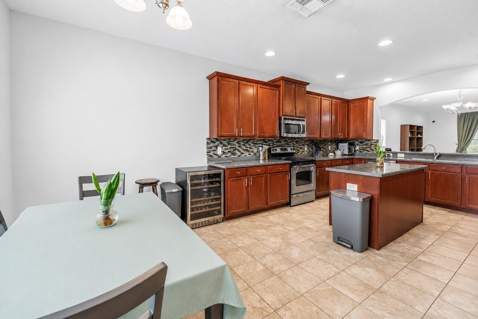 Kitchen With Dining Area and Wine Refrigerator