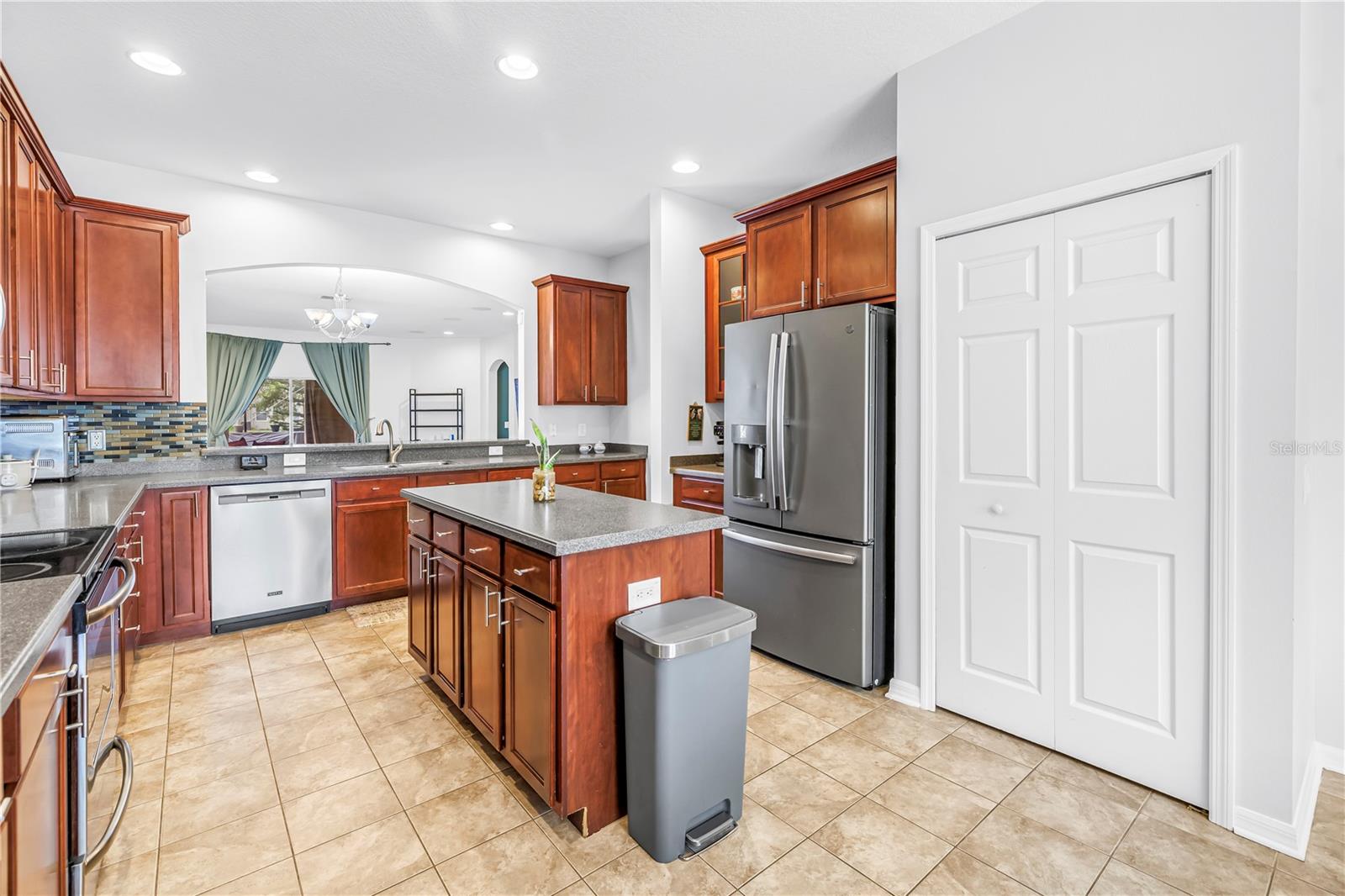 Kitchen With Island and View Into Living Area