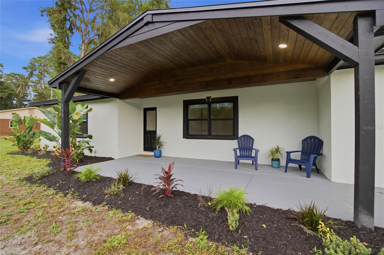 Fresh landscaping and a covered porch