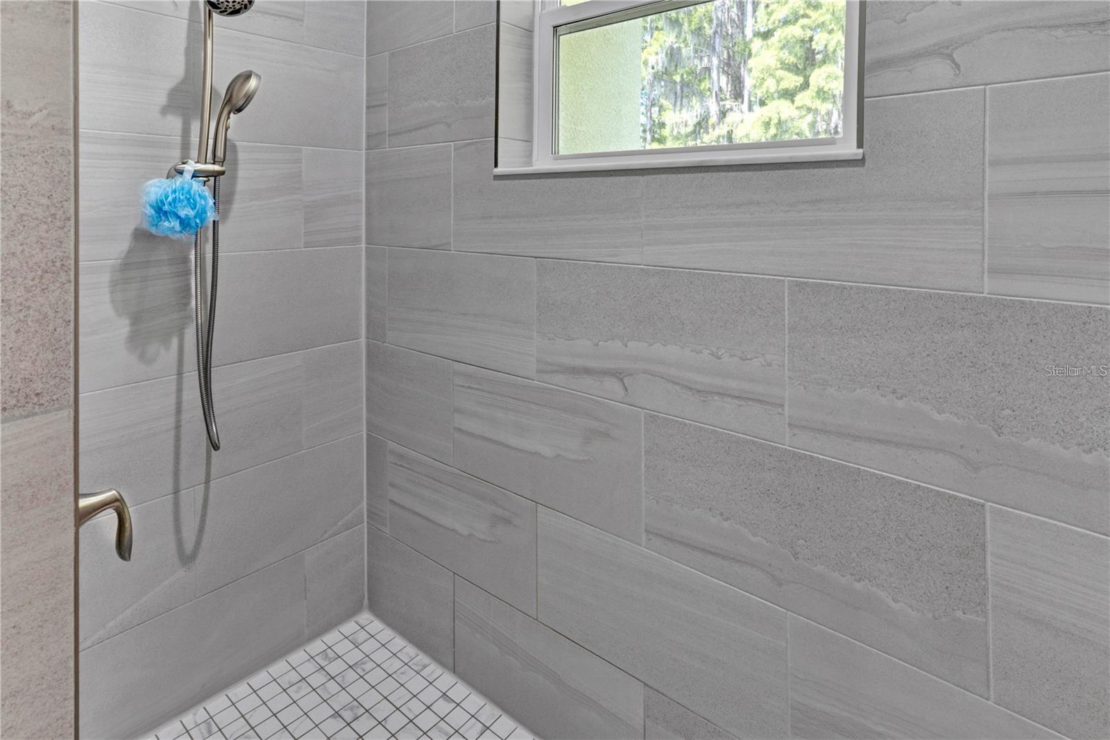 Large spacious shower in the primary bathroom.