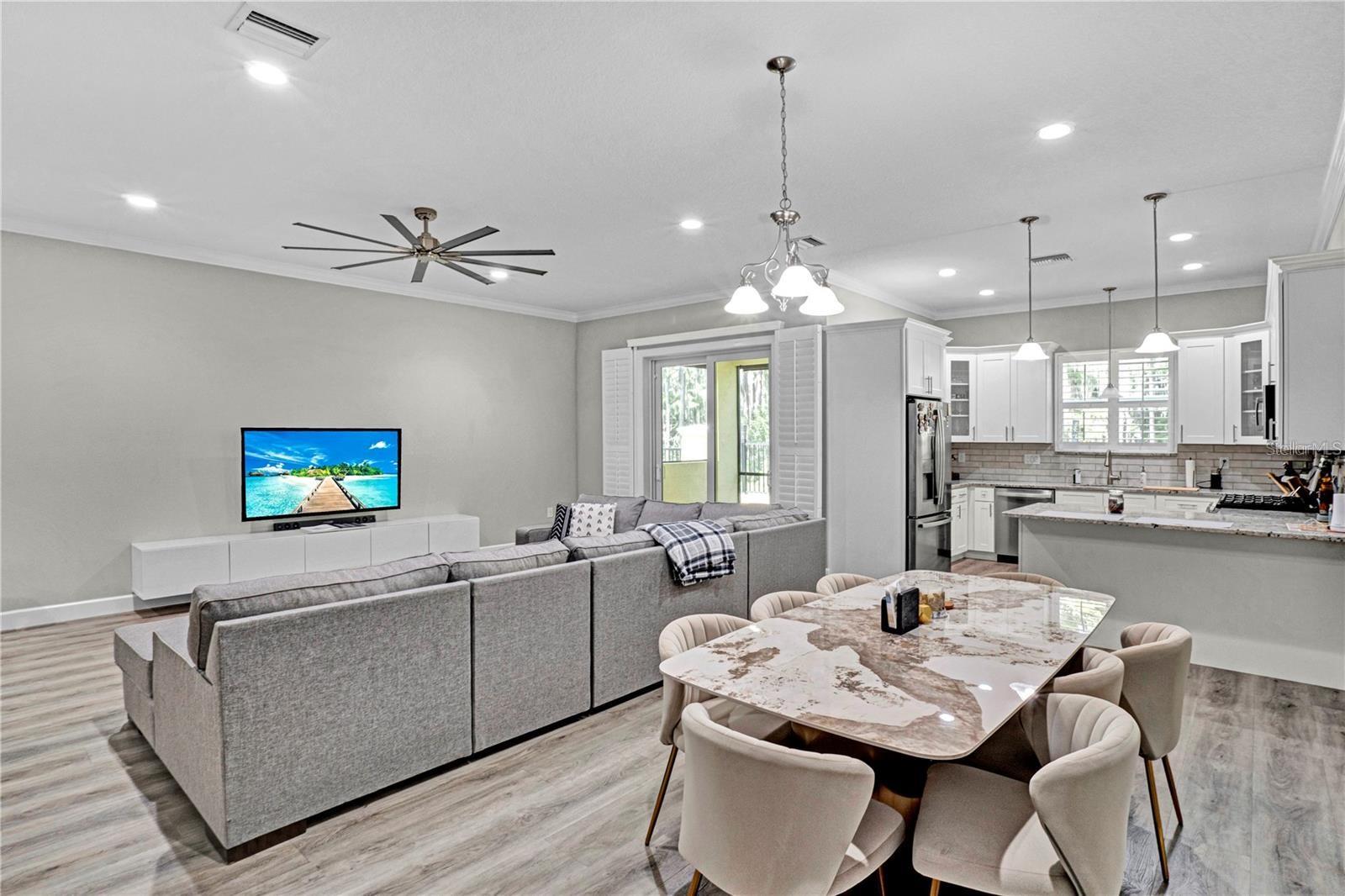 Perfect for entertaining, the seamless transition between the dining room, living area, and kitchen creates a bright, airy, and connected atmosphere.