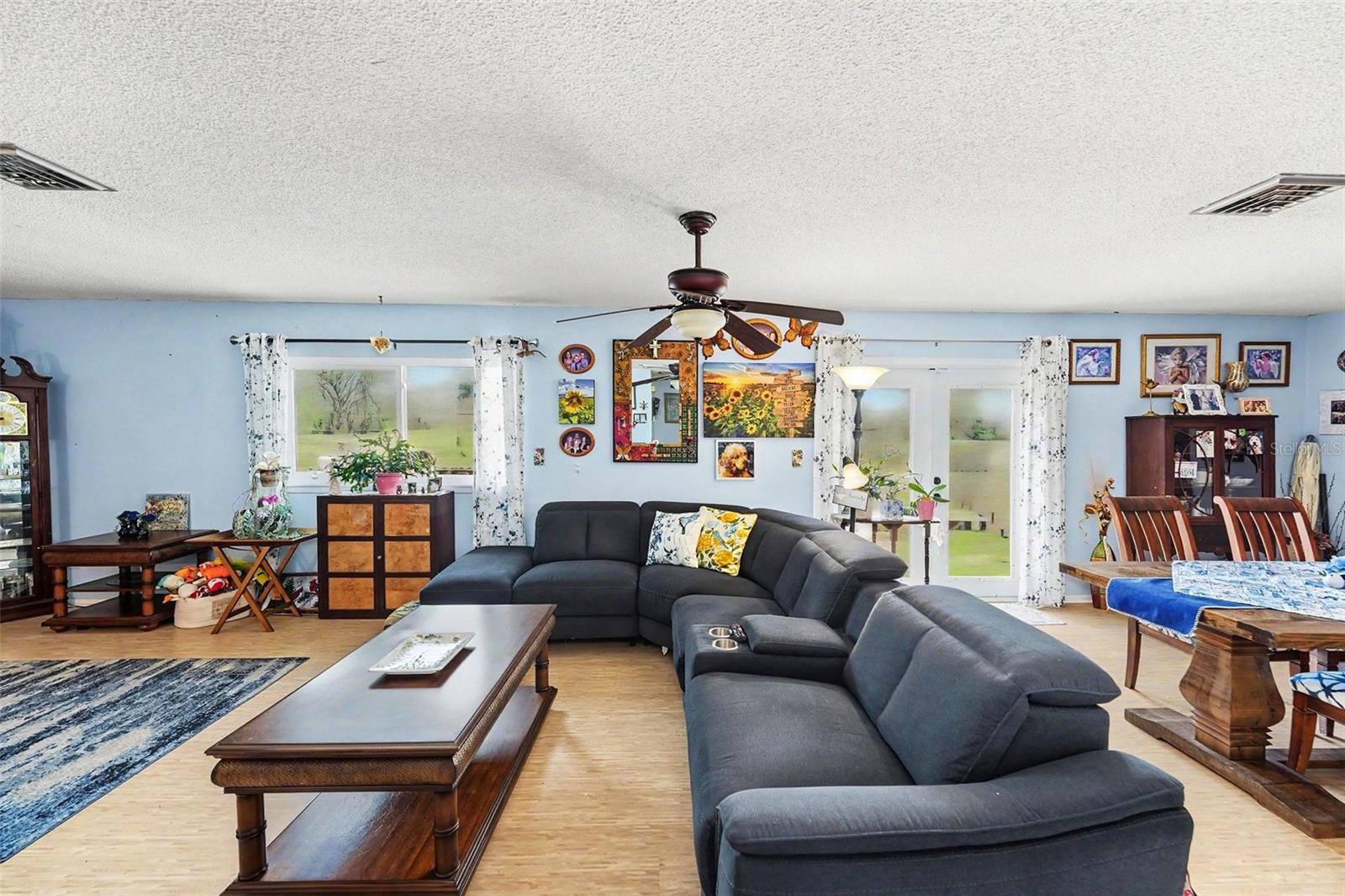 Open floor plan. The kitchen connects seamlessly to the dining and living areas. The french doors lead you to the  deck.
