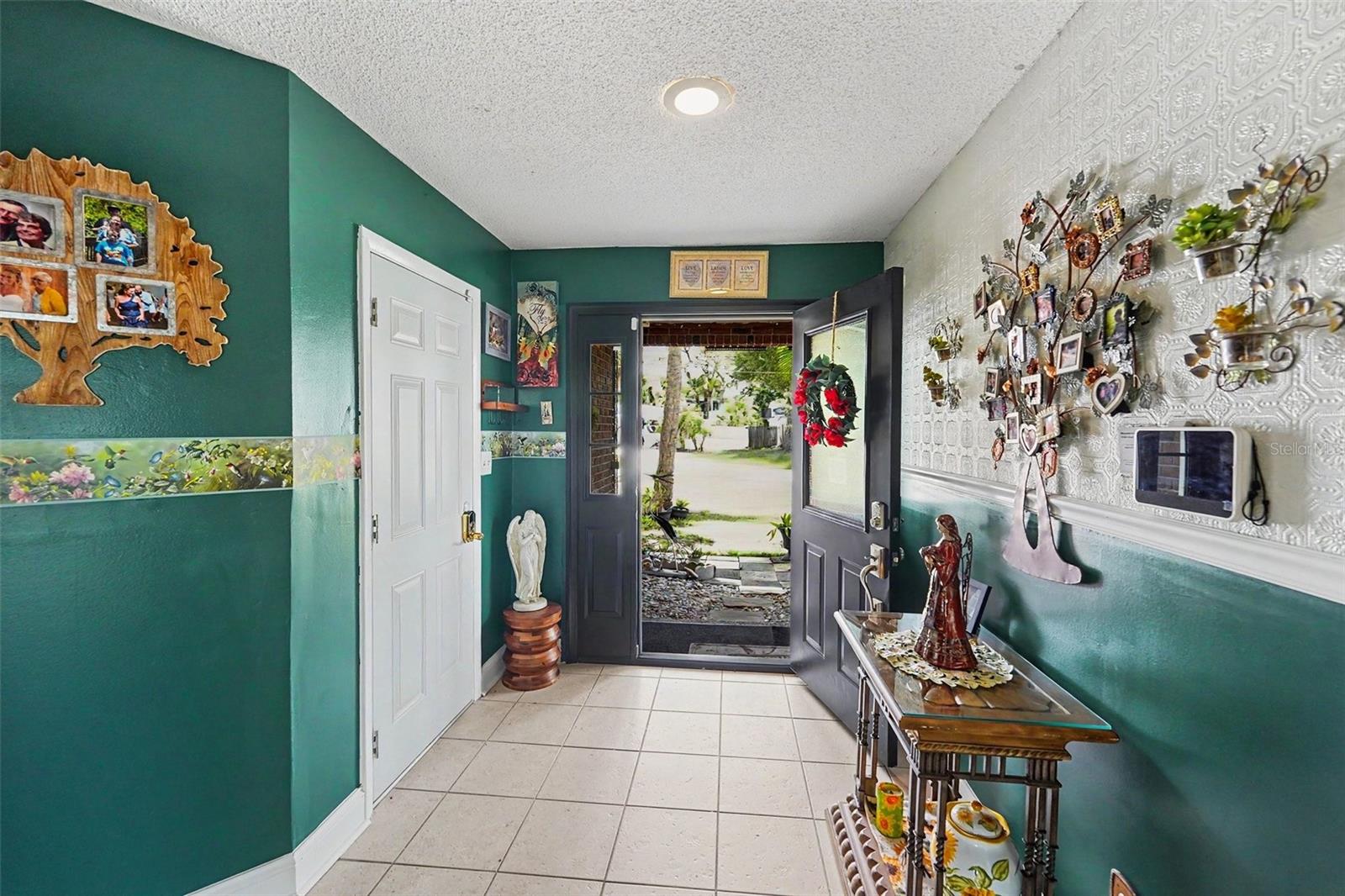 Foyer. The white door on the left take you to the 2-car garage. A staircase leads you to the living area.