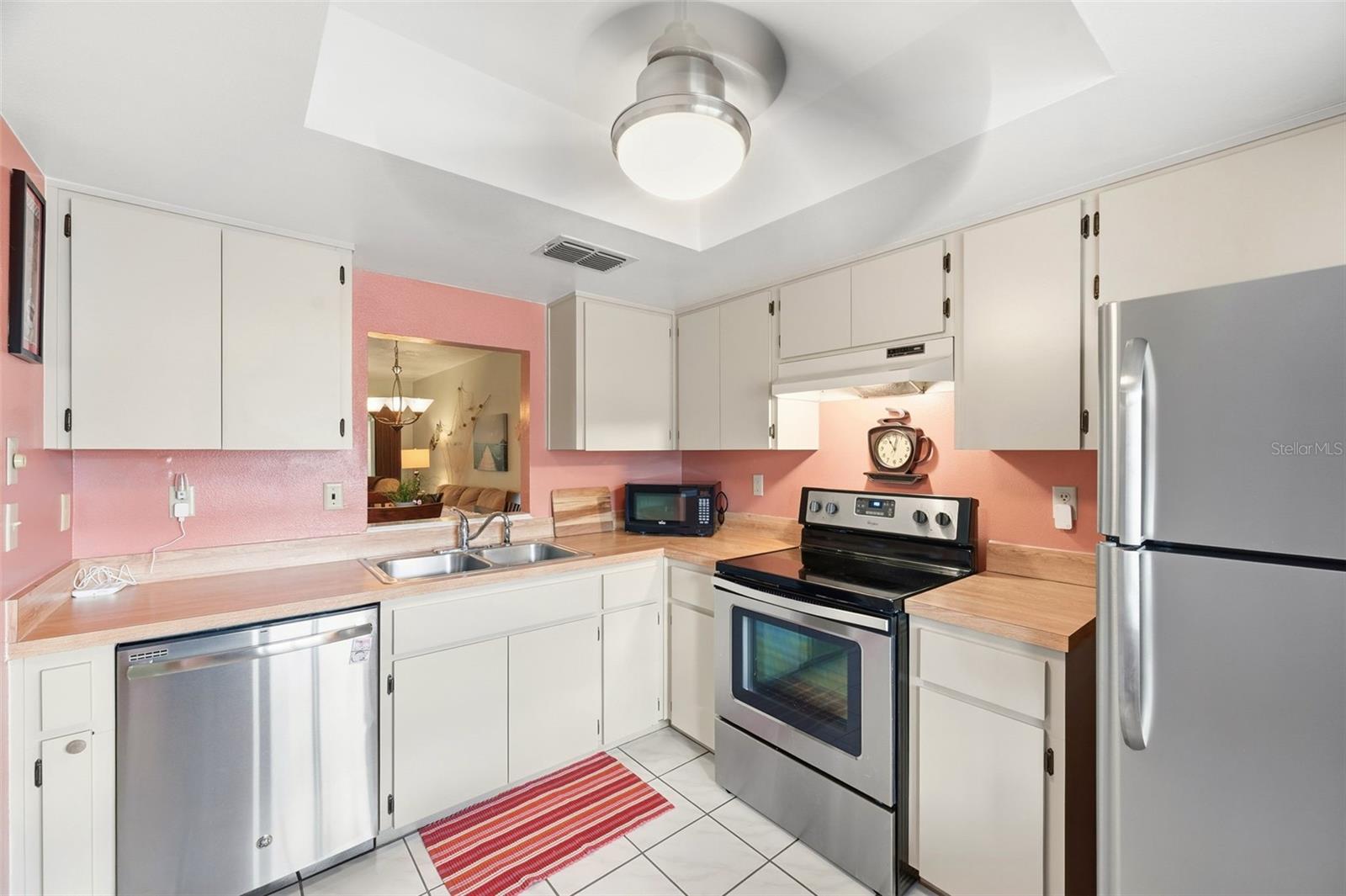 Updated appliances and a pass-through window overlooking the Dining Room/Living Room combo.