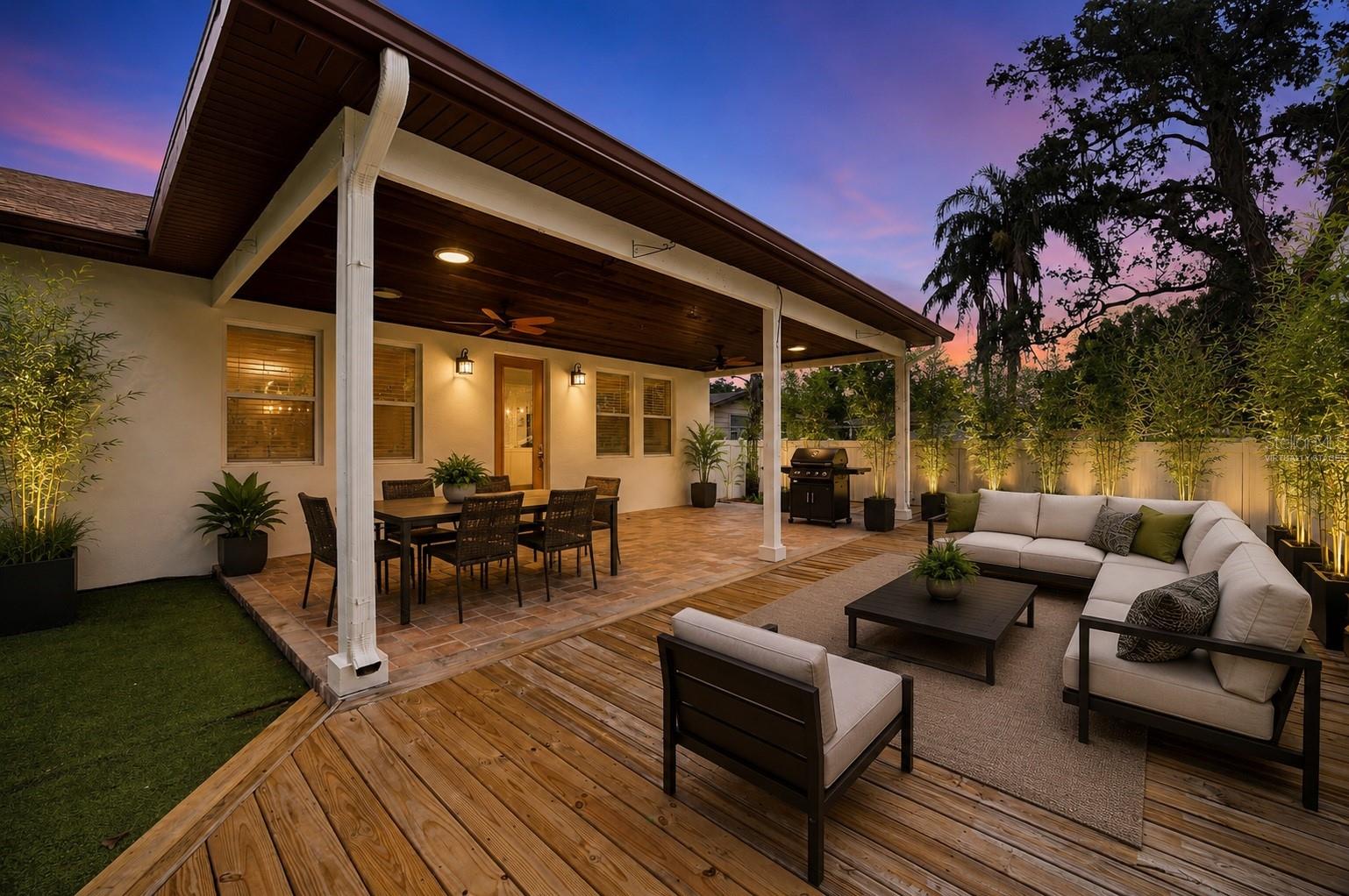 Patio Porch and Deck virtually Staged to show potential of the outdoor area. Plant, pots and landscape lights are all digital.