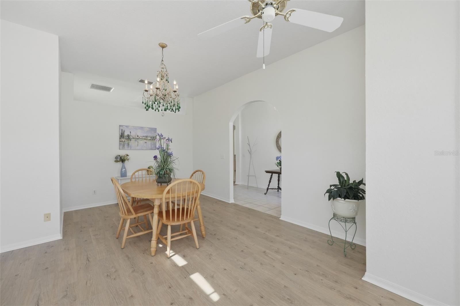 Large Front Room - Use as Dining/Office/Den High Ceilings, Newer LVT Flooring, & Arched Doorway