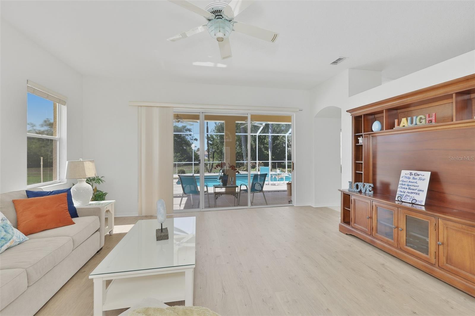 Living Room, Newer LVT Flooring, Sliders to Fabulous Pool & Outdoor Living Space