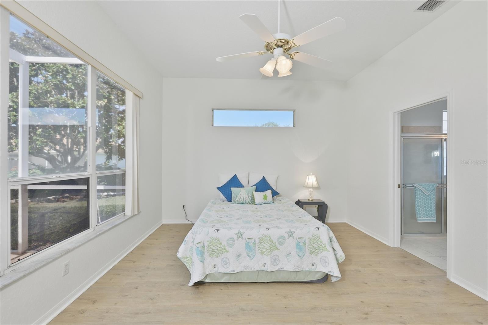 Large Primary Bedroom w/ Ensuite Bath, Plenty of Light, Newer LVT Flooring & View of the Pool & Wonderful Outdoor Living Space