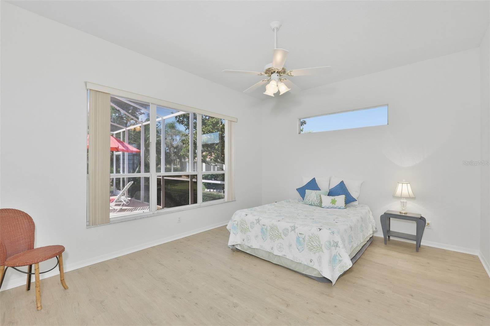 Large Primary Bedroom w/ Ensuite Bath, Plenty of Light, Newer LVT Flooring & View of the Pool & Wonderful Outdoor Living Space