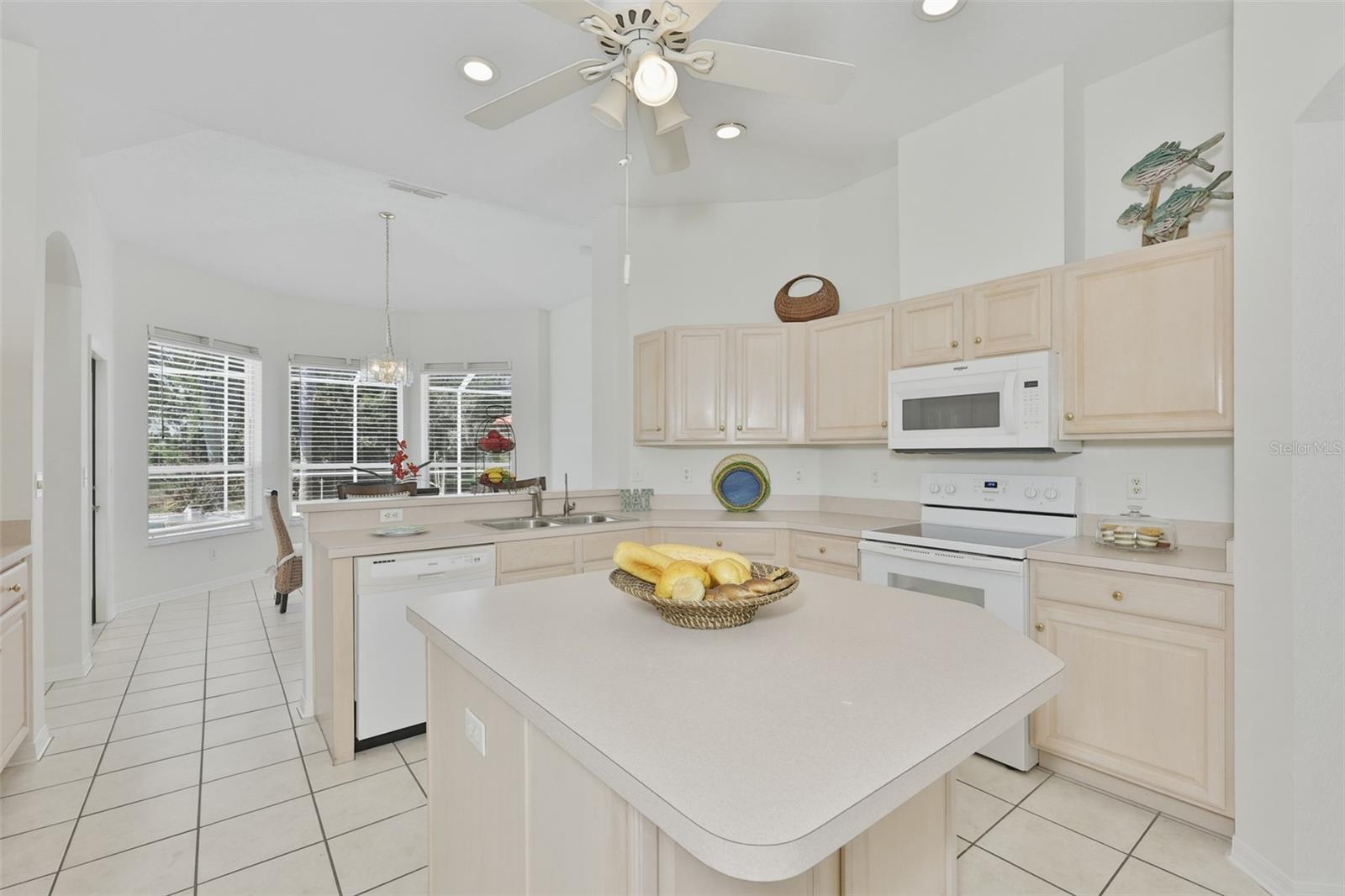 Refaced Cabinets, Tiled Floor, Large Center Island with Storage, Eat In Dinette With Great View of Pool & Rear Greenspace