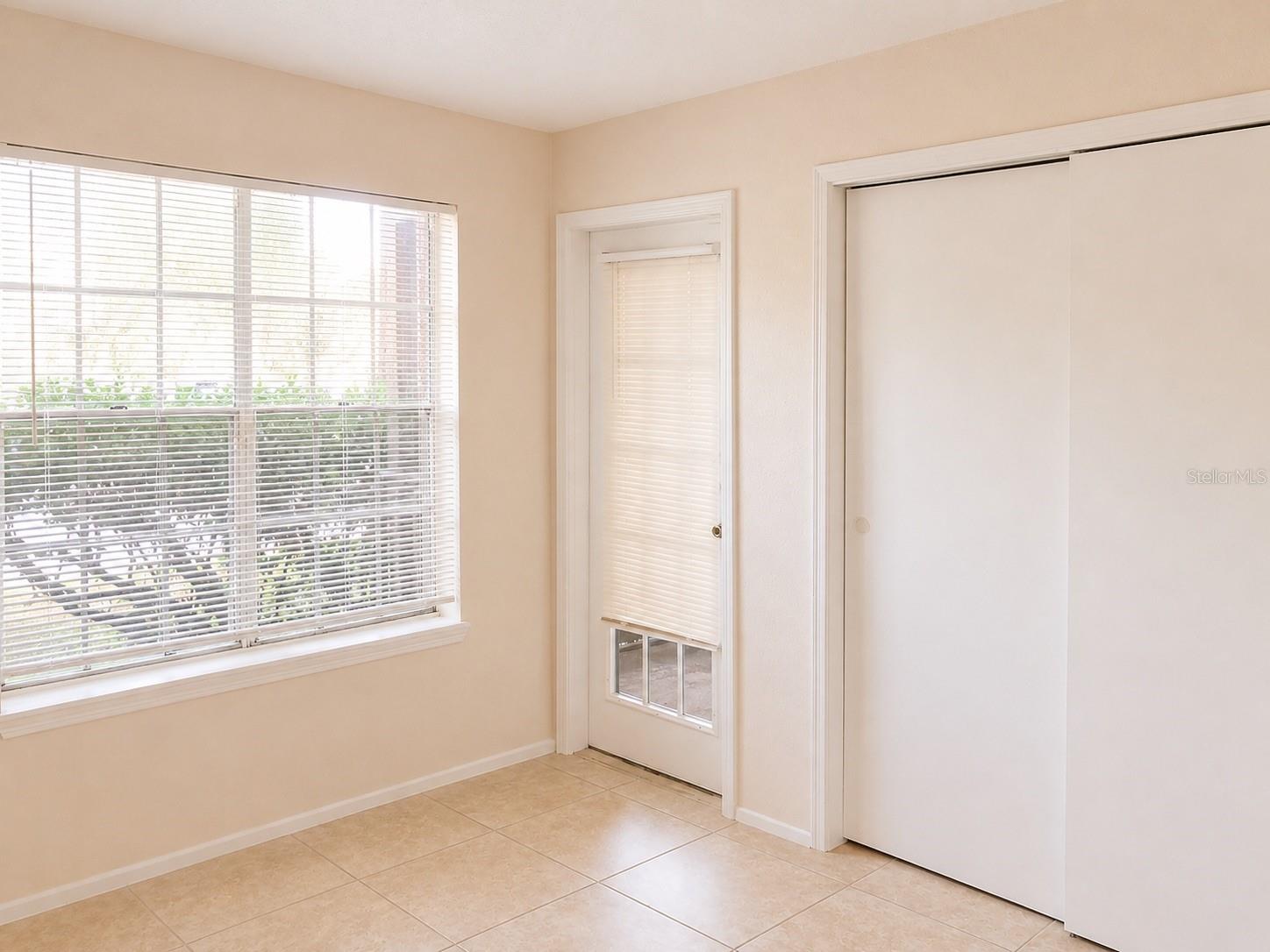 Bedroom #2 with access to screened in patio