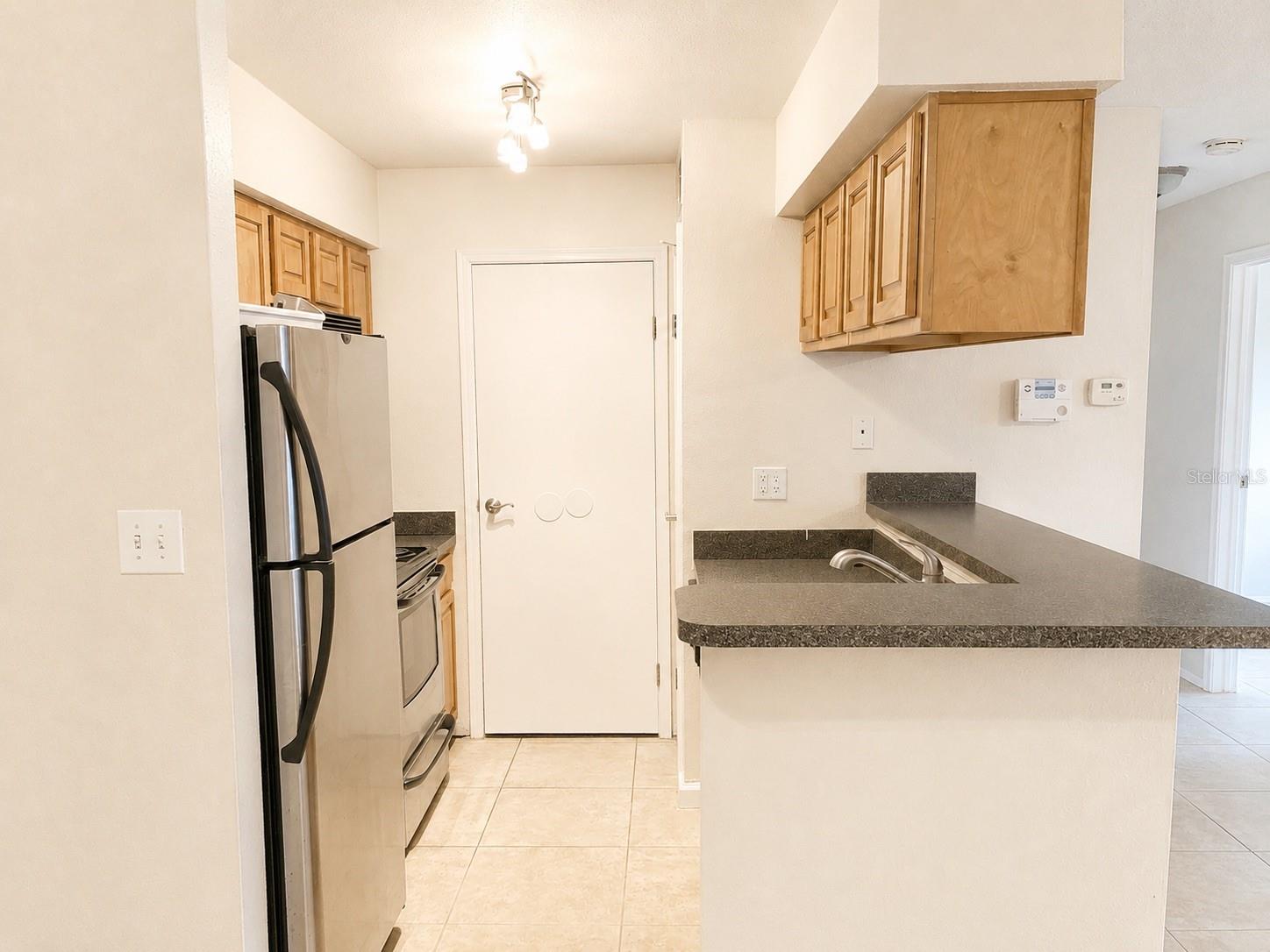 Kitchen with convenient in-unit laundry.