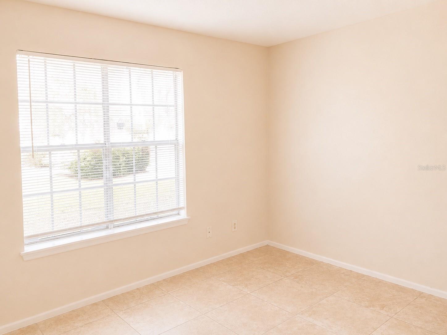 Bright primary bedroom filled with natural light.