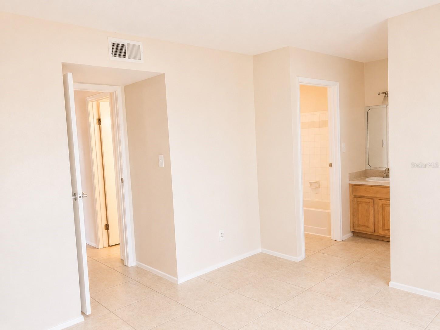 Primary bedroom with built-in vanity and sink.