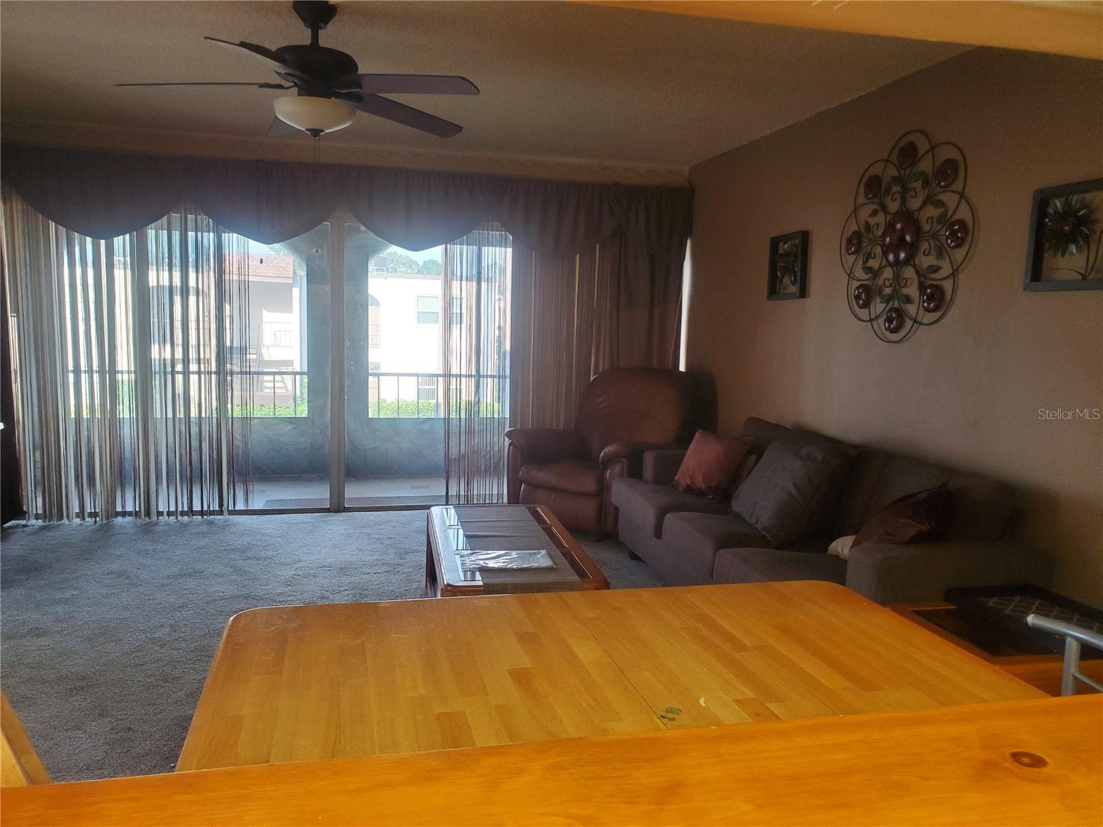 Kitchen pass-through looking into dining area and living room