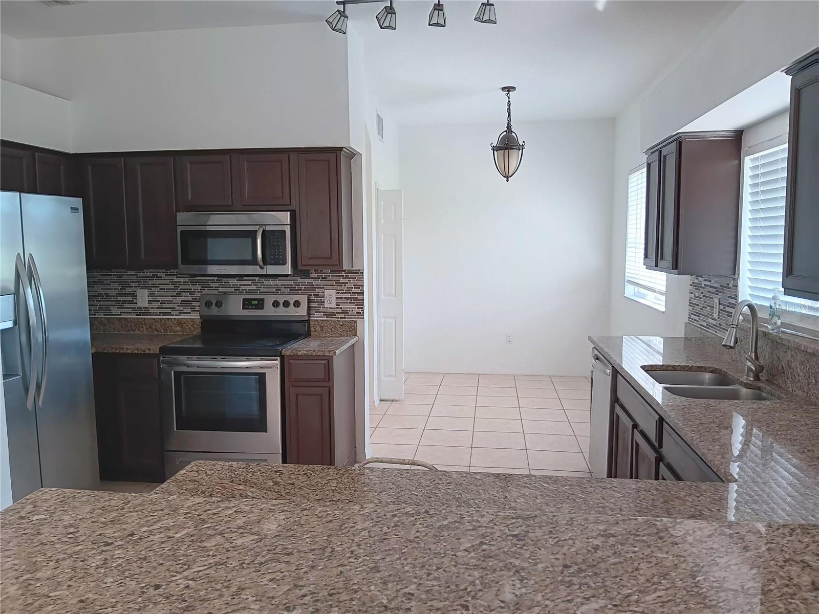 KITCHEN WITH GRANITE COUNTERTOP, BACKSPLASH, STAINLESS STEEL SINK, FAUCET AND APPLIANCES