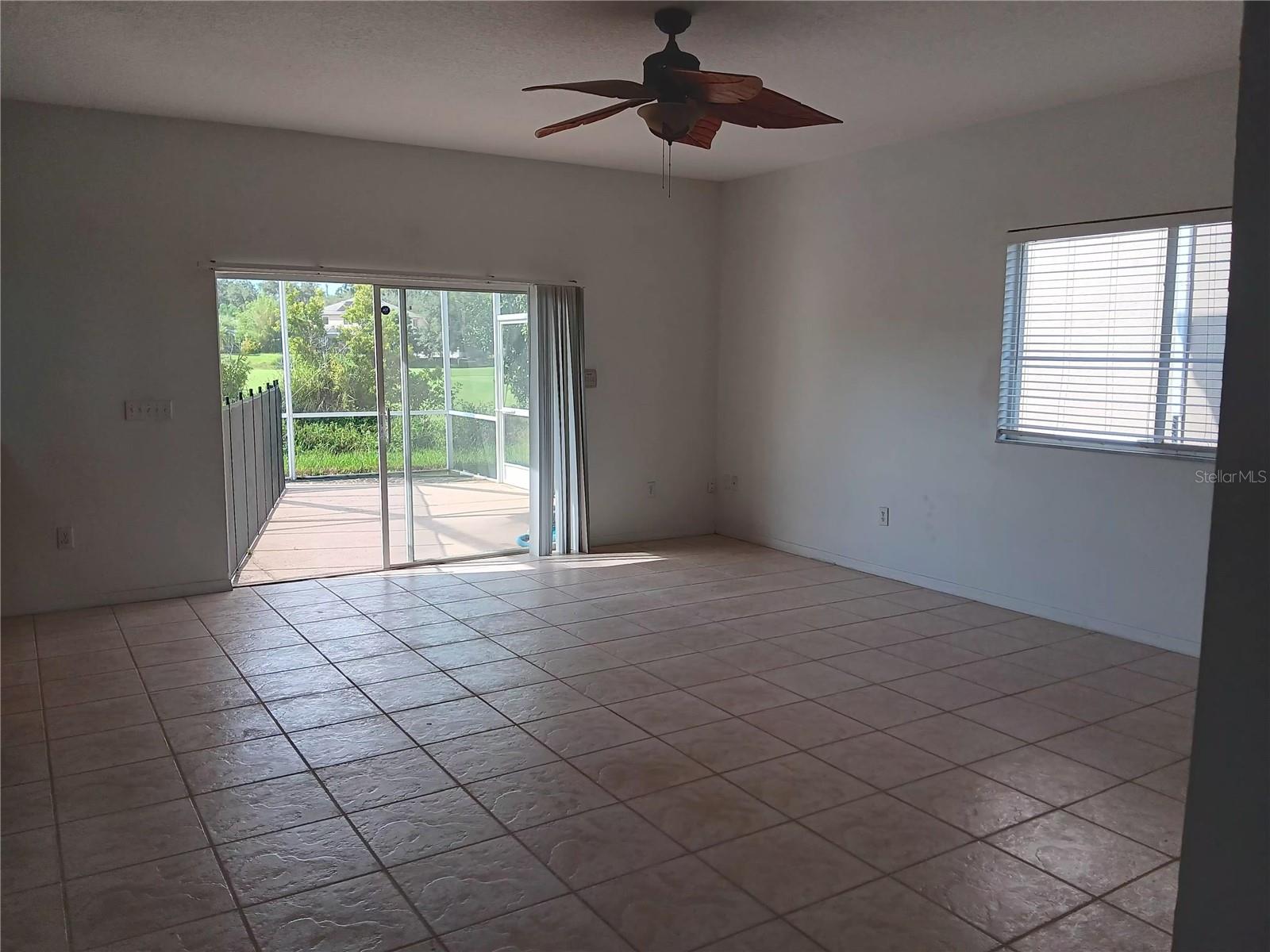 FAMILY ROOM WITH SLIDING DOOR TO POOL
