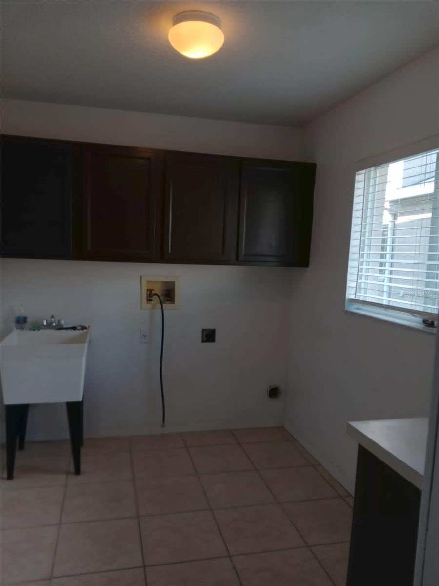 LAUNDRY ROOM WITH ENTRY DOOR IN GARAGE