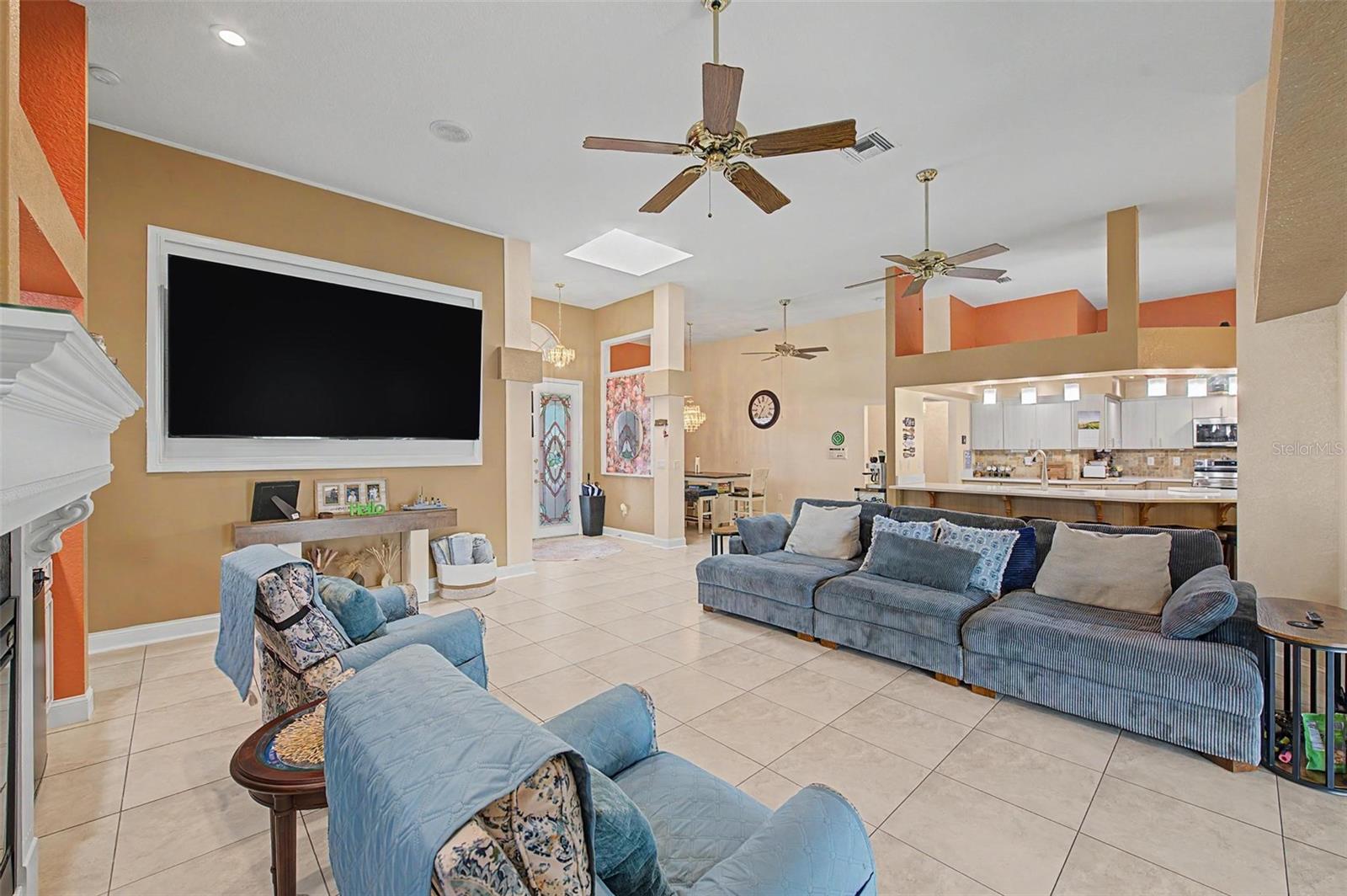 Large family room and the kitchen in the background.
