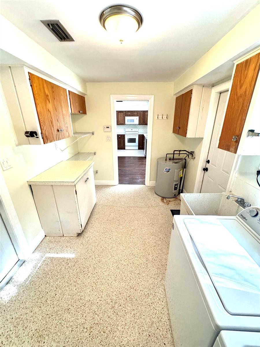 Huge inside laundry/utility room with folding table and extra storage