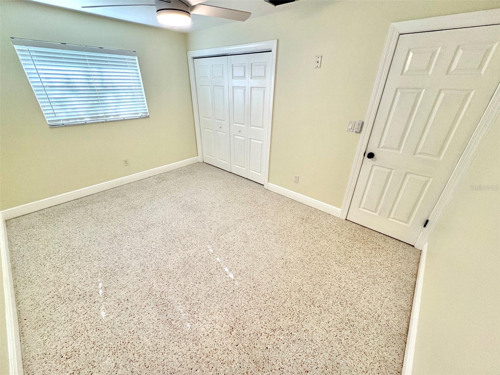 Bedroom one - not the updated doors and wood baseboard.  The terrazzo is in great shape