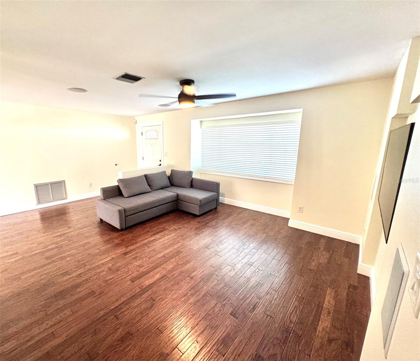 Living room has wall and ceiling mounted surround sound speakers