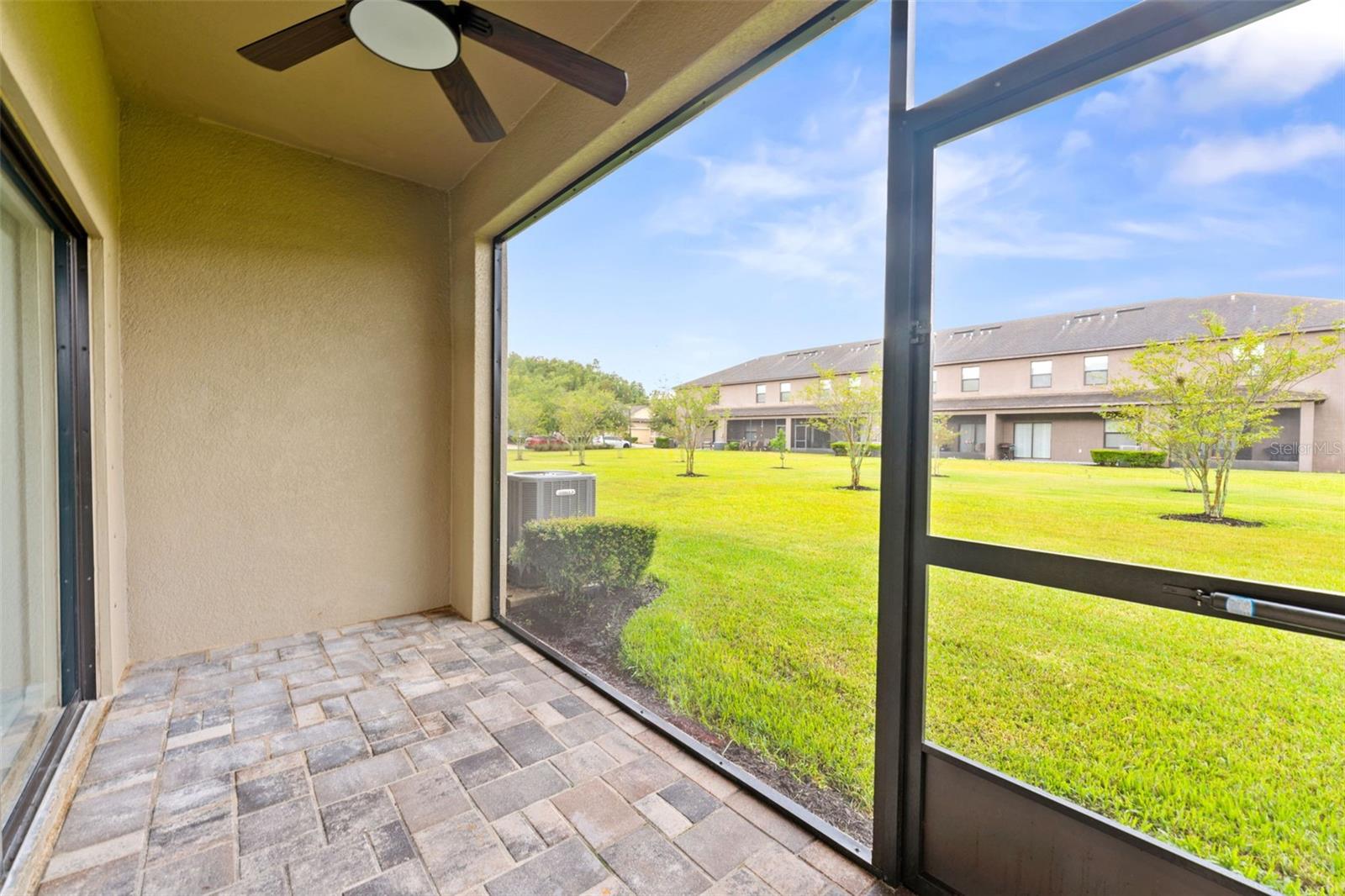 Step outside to your screened-in paver patio, the perfect spot for morning coffee or winding down at the end of the day