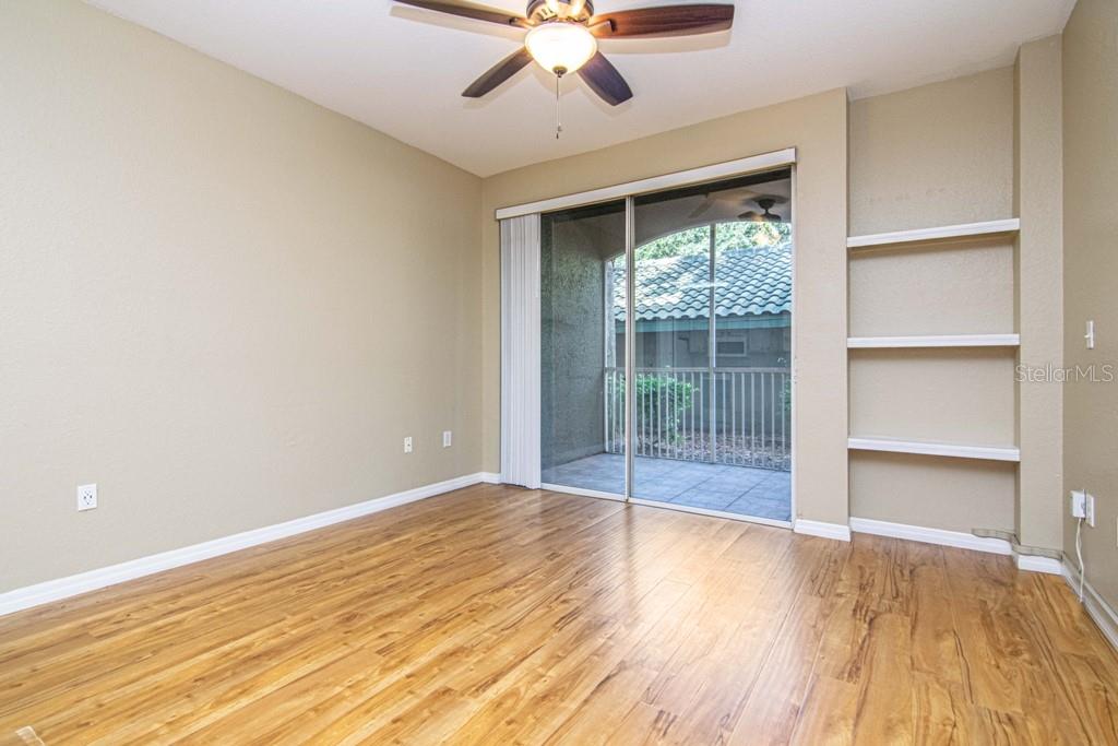 Living Room w/ Built-In Shelved and Hardwood Floors