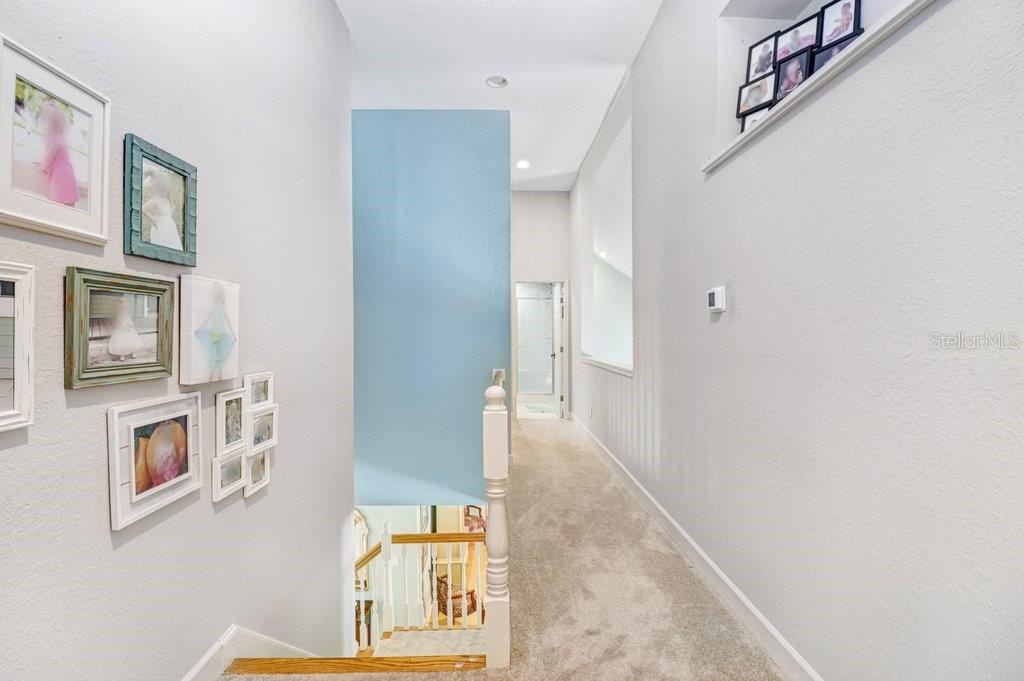 Hallway with pot shelves and open area to the Great Room