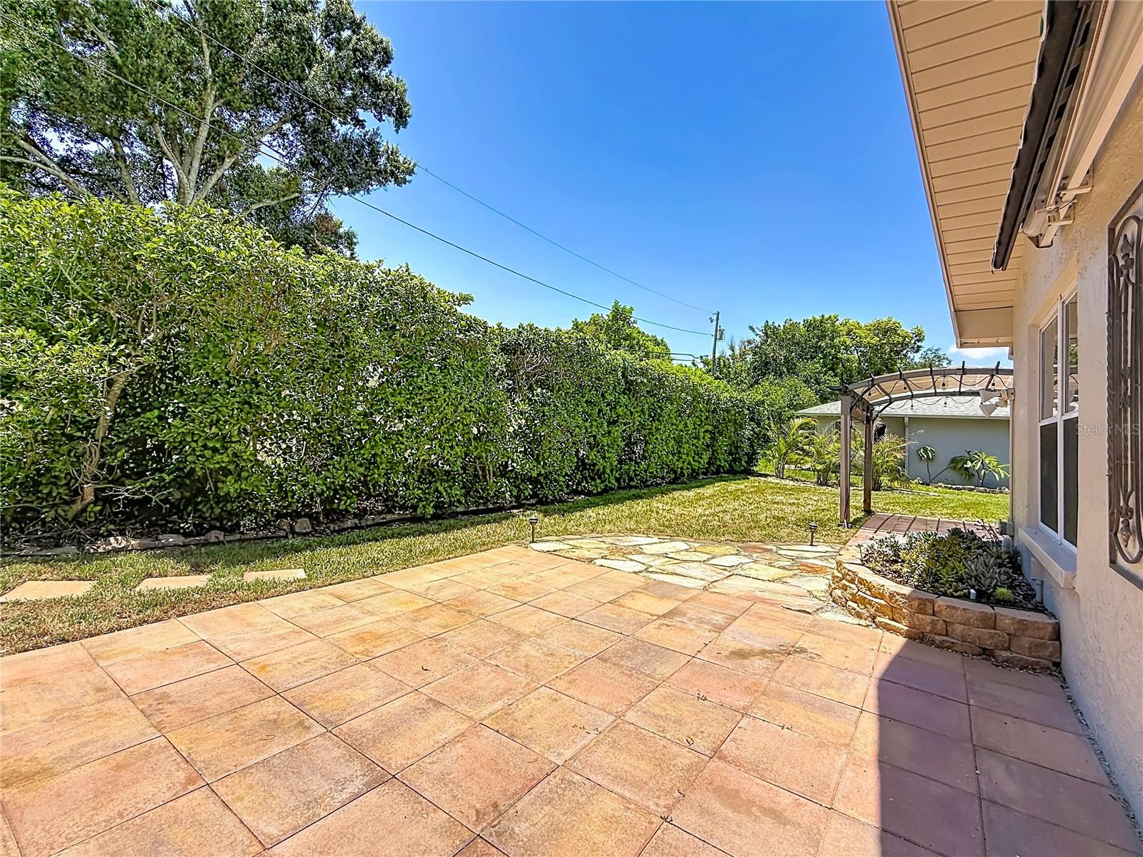 Patio overlooking Rear Green Space and Succulent Bed