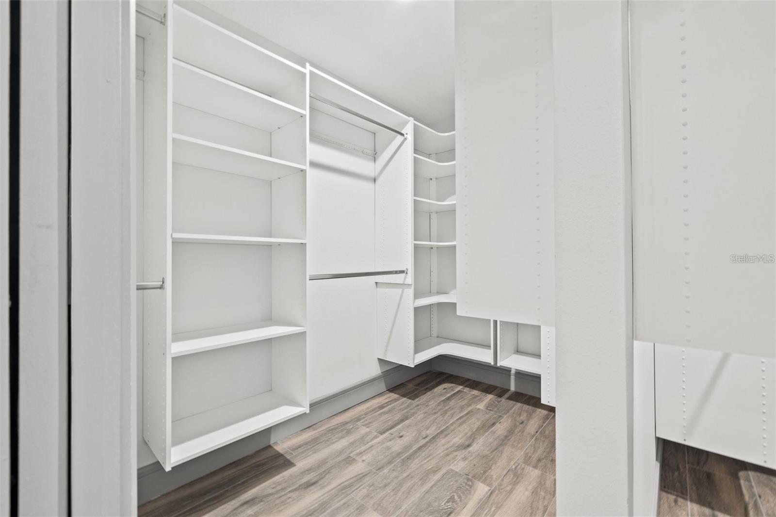 Primary bedroom walk in closet