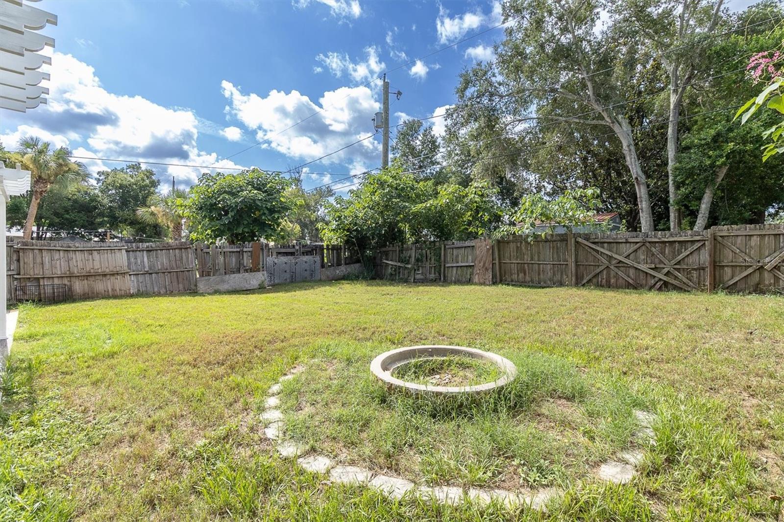 spacious fenced yard with firepit