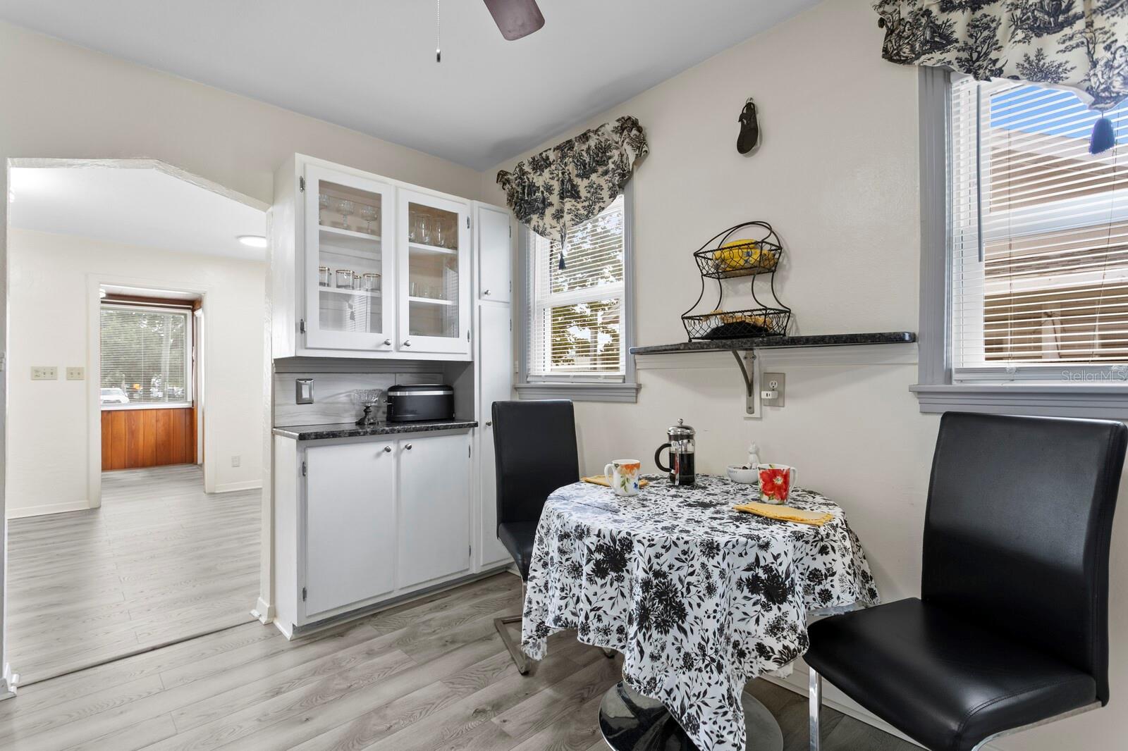 Eat-In area between two solid wood original cabinets with granite counters.