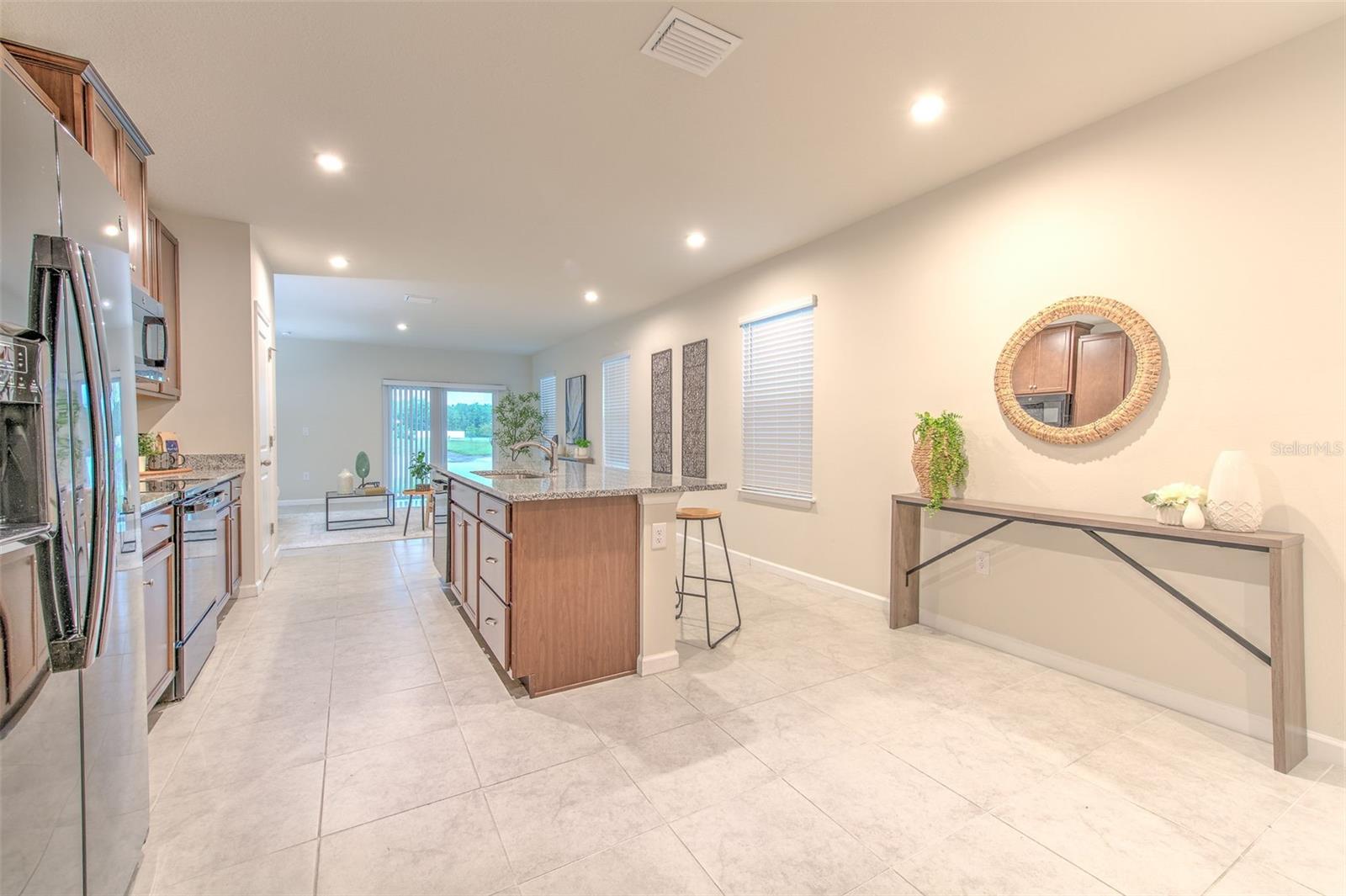 Kitchen view of Family Room by Refrigerator