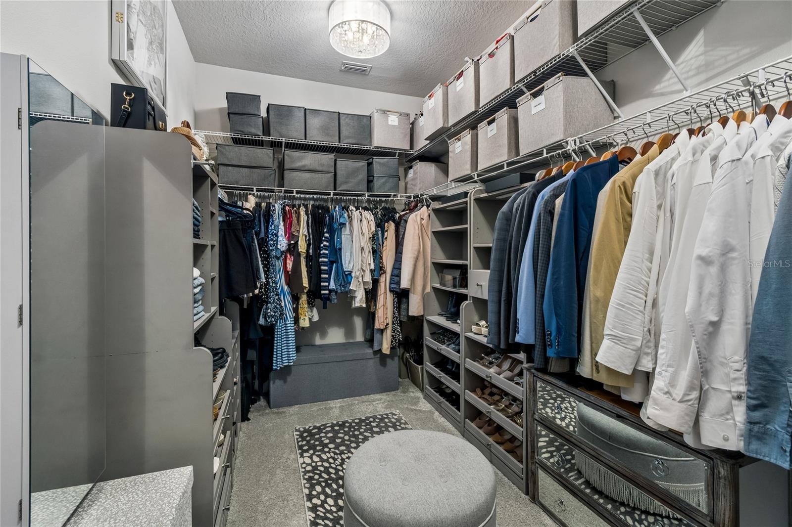 Primary walk-in closet with custom built-ins